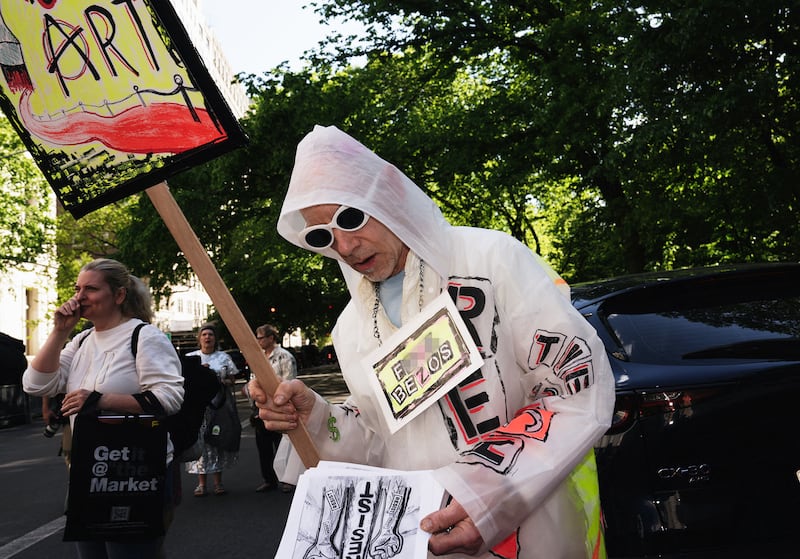 A costumed demonstrator participates in a “Resistance Red Carpet” protest against the Met Gala, the star-studded fundraiser known for its extravagant fashion and high-profile guests, in New York City, on May 4, 2026.