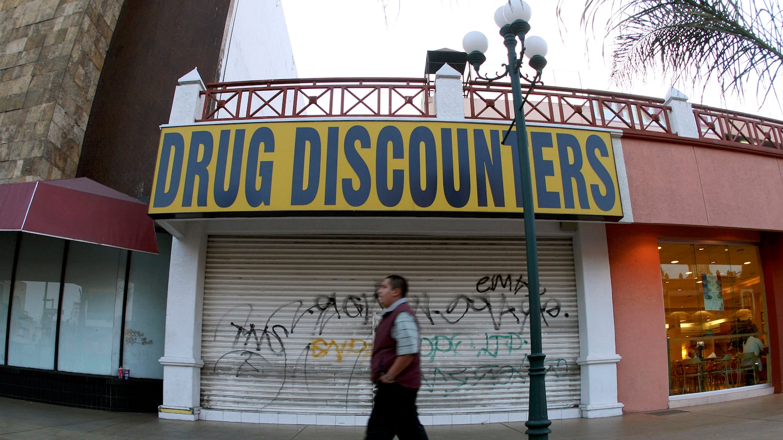A man walks past a closed down store at the Revolucion Avenue in the border city of Tijuana May 13, 2008.