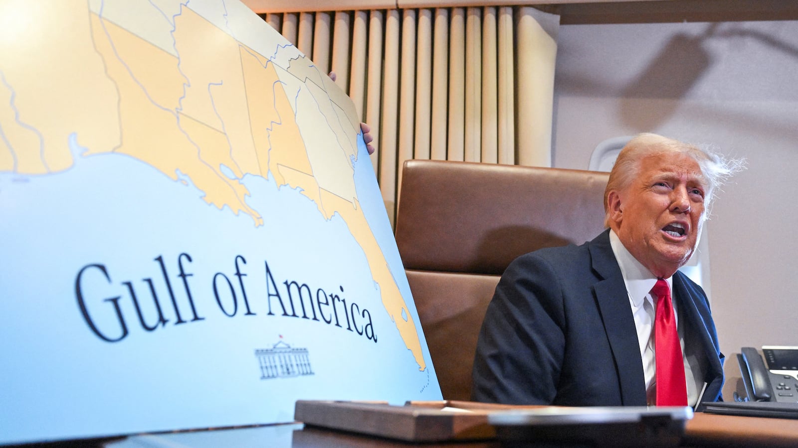 US President Donald Trump speaks to the press before signing a proclamation renaming the Gulf of Mexico as the Gulf of America aboard Air Force One enroute to New Orleans, Louisiana on Febrary 09, 2025.