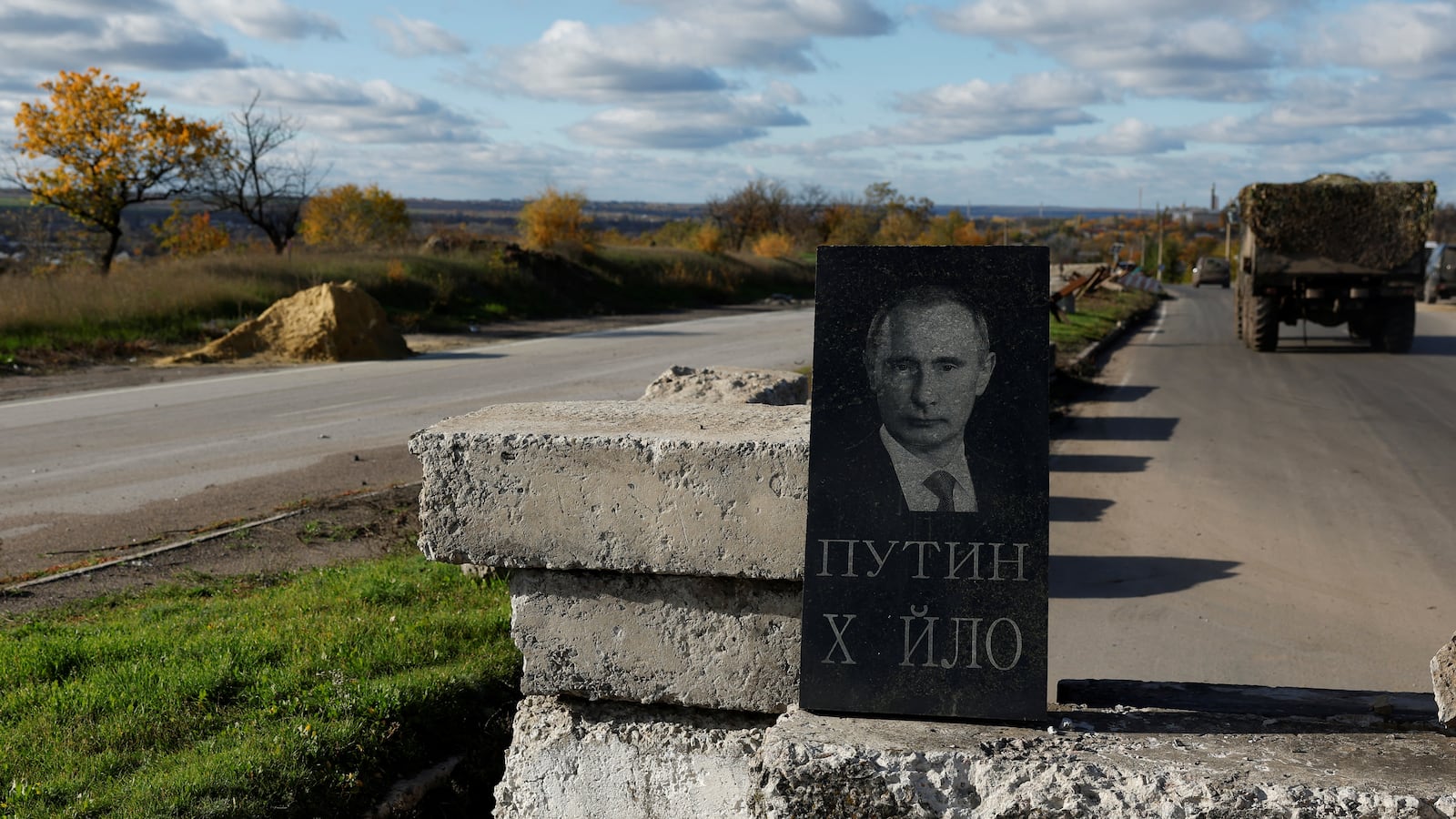 A mock headstone for the grave of Russian President Vladimir Putin is seen at a military checkpoint, as Russia's invasion of Ukraine continues, in Bakhmut, Ukraine.