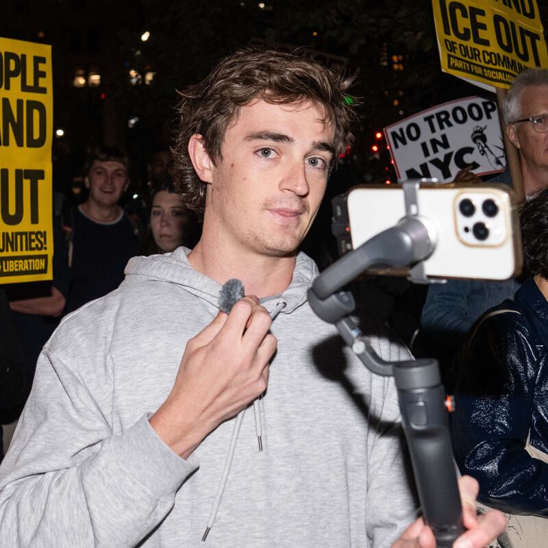 NEW YORK, NEW YORK - OCTOBER 22: Conservative influencer Nick Shirley films protestors demonstrating against U.S. Immigration and Customs Enforcement (ICE) arrests on October 22, 2025 in New York City. Federal agents arrested nine individuals during an operation on Manhattan's Canal Street on Tuesday, targeting undocumented immigrants potentially linked to illegal street vending, according to officials and a senior law enforcement source familiar with the investigation. (Photo by Adam Gray/Getty Images)