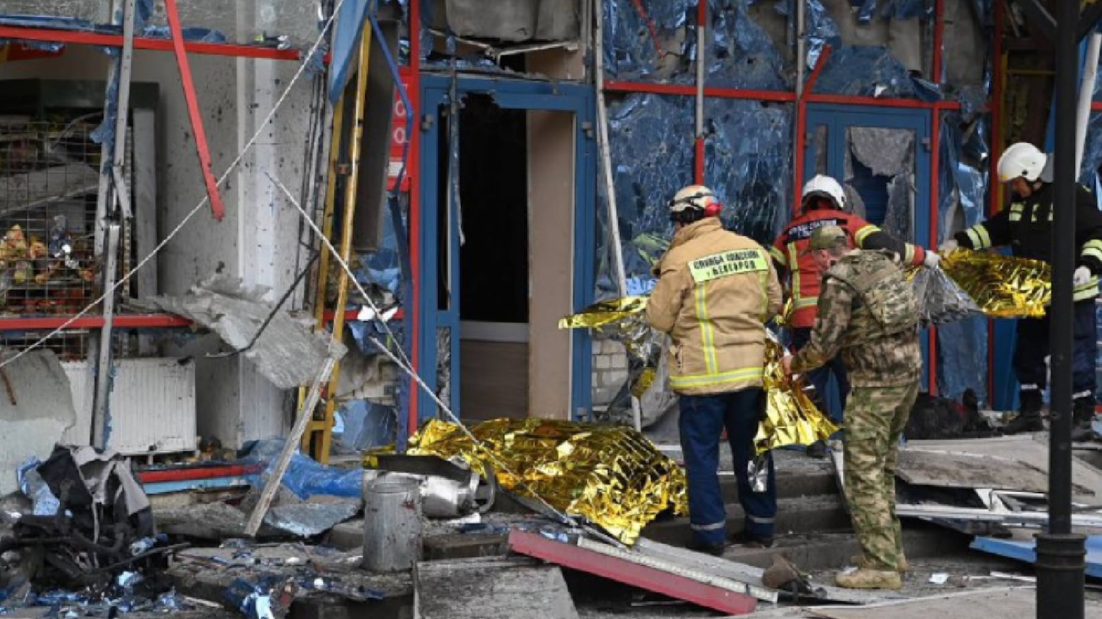First responders examine the scene of a reported missile strike in Russia's Belgorod.
