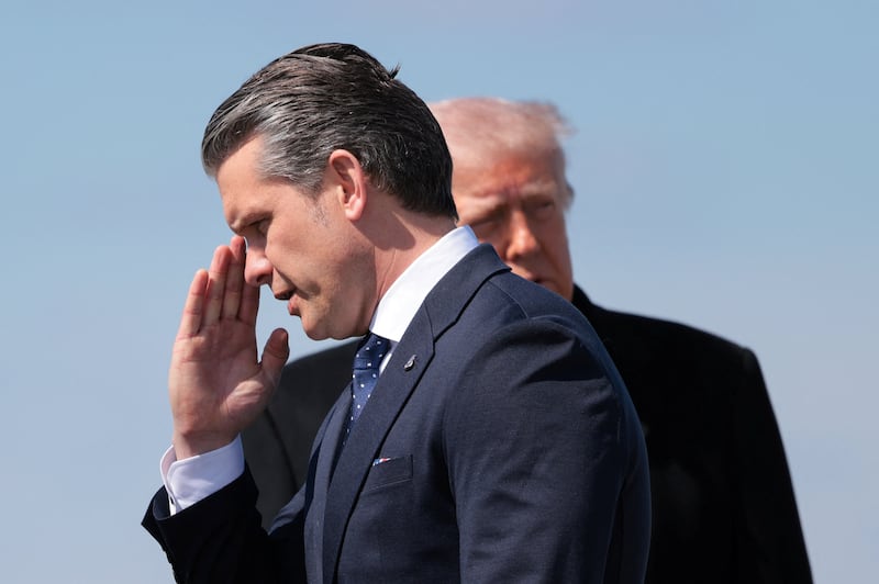 U.S. Secretary of Defense Pete Hegseth salutes, as he and President Donald Trump arrive at Dover Air Force Base in Dover, Delaware, U.S., March 18, 2026