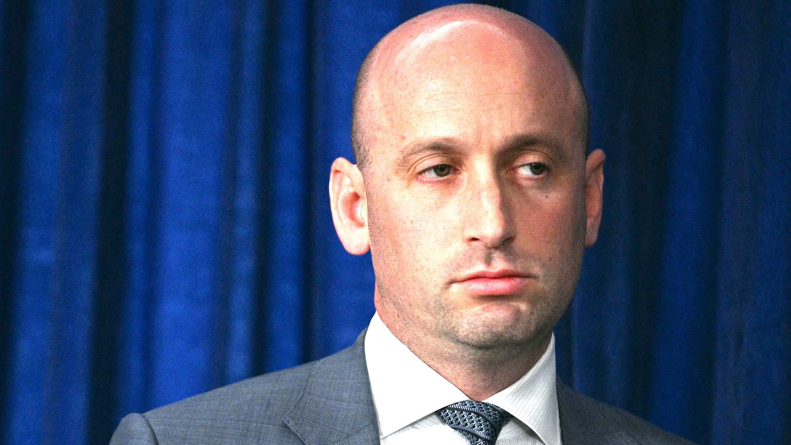 White House Deputy Chief of Staff Stephen Miller looks on as President Donald Trump speaks to the press following US military actions in Venezuela, at his Mar-a-Lago residence in Palm Beach, Florida, on January 3, 2026. President Trump said Saturday that US forces had captured Venezuelan leader Nicolas Maduro after launching a "large scale strike" on the South American country.