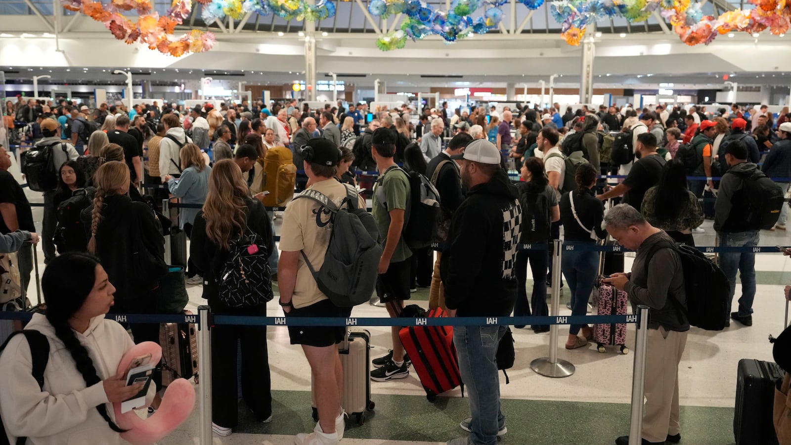 HOUSTON, TEXAS - NOVEMBER 7: People are shown in line in Terminal E at George Bush Intercontinental Airport in Houston Friday, Nov. 7, 2025. (Melissa Phillip/Houston Chronicle via Getty Images)