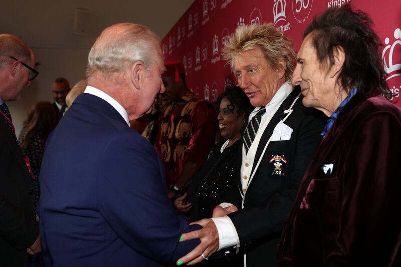 Britain's King Charles III speaks with British rock legends Rod Stewart and Ronnie Wood as he arrives to attend A King's Trust Celebration to mark the 50th anniversary of the charity, at the Royal Albert Hall, London, Britain, May 11, 2026.