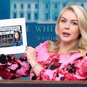White House Press Secretary Karoline Leavitt displays a printed paper that reads "media coverage of Sheridan Gorman" as she speaks during a press briefing in the James S. Brady Press Briefing Room at the White House in Washington, D.C., U.S., March 30, 2026.