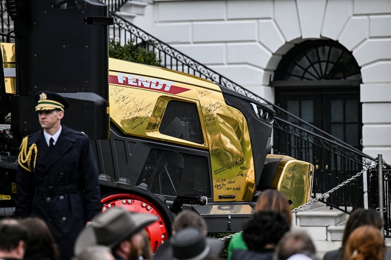 Signed gold machinery is displayed during an event held by President Donald Trump to give remarks to farmers, on the South Lawn of the White House on March 27, 2026.