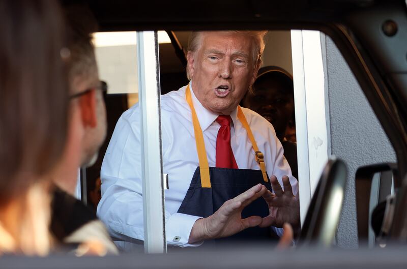 Republican presidential nominee, former U.S. President Donald Trump works the drive-through line during a campaign photo op as he visits a McDonald's restaurant on October 20, 2024 in Feasterville-Trevose, Pennsylvania. Trump is campaigning the entire day in the state of Pennsylvania. Trump and Democratic presidential nominee Vice President Kamala Harris continue to campaign in battleground swing states ahead of the November 5 election. (Photo by Win McNamee/Getty Images)