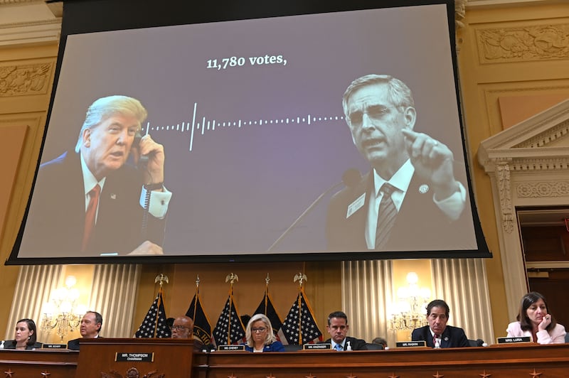 Members of the House Select Committee hearing to Investigate the January 6th Attack sit under a screen showing former US President Donald Trump and an excerpt of a phone call he had with Georgia Secretary of State Brad Raffensperger in the aftermath of the US Presidential Election, during the fourth hearing by the House Select Committee to Investigate the January 6th Attack on the US Capitol in the Cannon House Office Building in Washington, DC, on June 21, 2022. (Photo by ROBERTO SCHMIDT / AFP) (Photo by ROBERTO SCHMIDT/AFP via Getty Images)