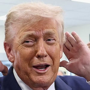 U.S. President Donald Trump checks his hair before sitting down for a podcast interview at the Varsity restaurant, in Rome, Georgia, U.S., February 19, 2026. REUTERS/Kevin Lamarque