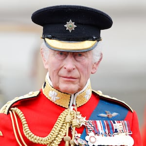 King Charles III, wearing his Irish Guards uniform, takes the salute from a dais outside Buckingham Palace after Trooping the Colour on June 15, 2024 in London, England. Trooping the Colour, also known as The King's Birthday Parade, is a military ceremony to mark the official birthday of the British Sovereign. The ceremony takes place at Horse Guards Parade followed by a flypast over Buckingham Palace and was first performed in the mid-17th century during the reign of King Charles II. The parade features all seven regiments of the Household Division with Number 9 Company, Irish Guards being the regiment this year having their Colour Trooped. (Photo by Max Mumby/Indigo/Getty Images)