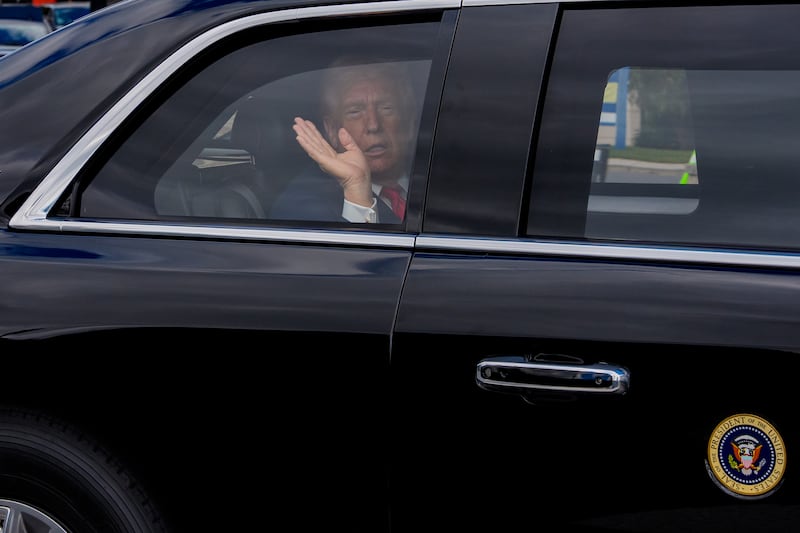 BETHESDA, MARYLAND - OCTOBER 10: U.S. President Donald Trump waves to members of the media as he is driven to Marine One while departing Walter Reed Medical Center on October 10, 2025 in Bethesda, Maryland. Trump traveled to Walter Reed to visit with troops and receive a medical check up. (Photo by Andrew Harnik/Getty Images)