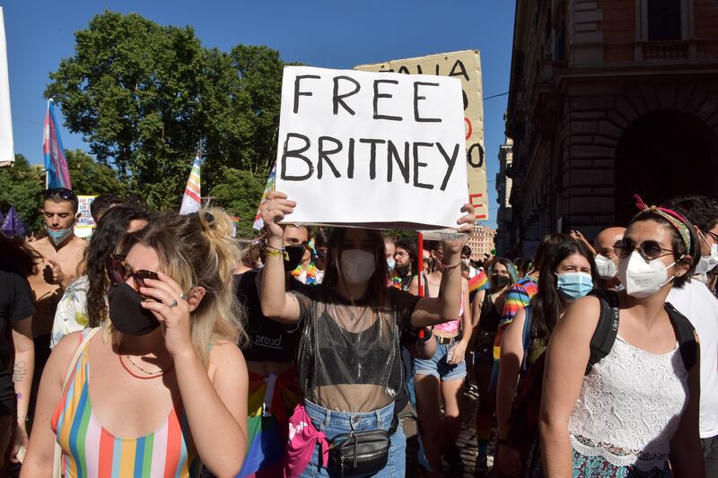 ROME, ITALY - JUNE 26: People with a sign saying Free Britney, referring to Britney Spears take part in Rome Pride, the LGBTQIA+ parade, on June 26, 2021 in Rome, Italy. The Italian prime minister defended parliament after the Vatican requested a revision on an anti-discrimination draft bill that provides protection for LGBTQ persons, saying the new law could interfere with religious freedoms.