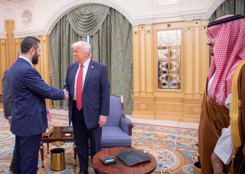 U.S. President Donald Trump meets with Syrian President Ahmed al-Sharaa in Riyadh, Saudi Arabia, in this handout released on May 14, 2025.