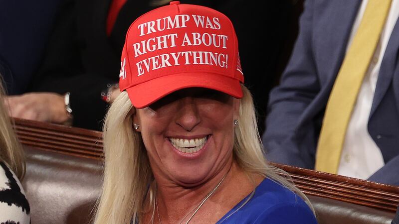 Marjorie Taylor Greene wearing a red hat reading "Trump was right about everything" at the U.S. Capitol.