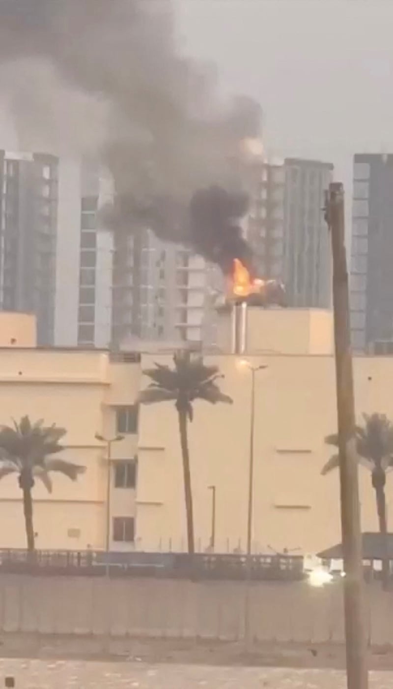 Smoke rises from the U.S. embassy building, after Iraqi security sources said the embassy was hit in a missile attack, in Baghdad, Iraq March 14, 2026 in this screen grab obtained from a social media video. SOCIAL MEDIA/via REUTERS  THIS IMAGE HAS BEEN SUPPLIED BY A THIRD PARTY.  NEWS USE ONLY. NO RESALES. NO ARCHIVES. BEST QUALITY AVAILABLE. VERIFICATION - Reuters was able to confirm the video from the shape and location of buildings and a water body which matched file and satellite imagery of the area. Date was verified by Iraqi security sources and media reports. Multiple corroborating videos showed smoke rising from the building. No older versions of the video were found posted online before March 14