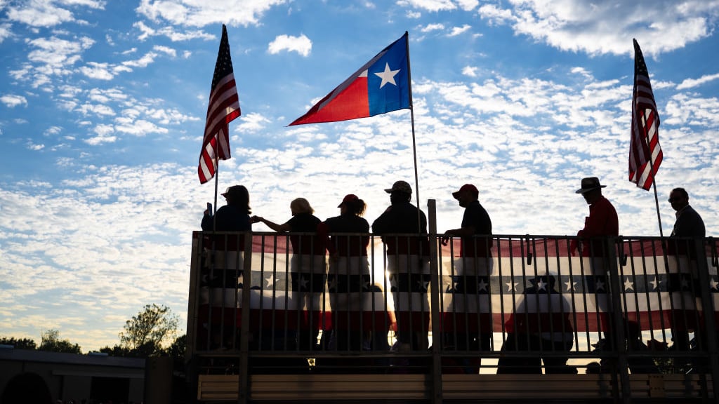 Supporters listen from risers as Republican presidential candidate former U.S. President Donald Trump speaks during a campaign rally.