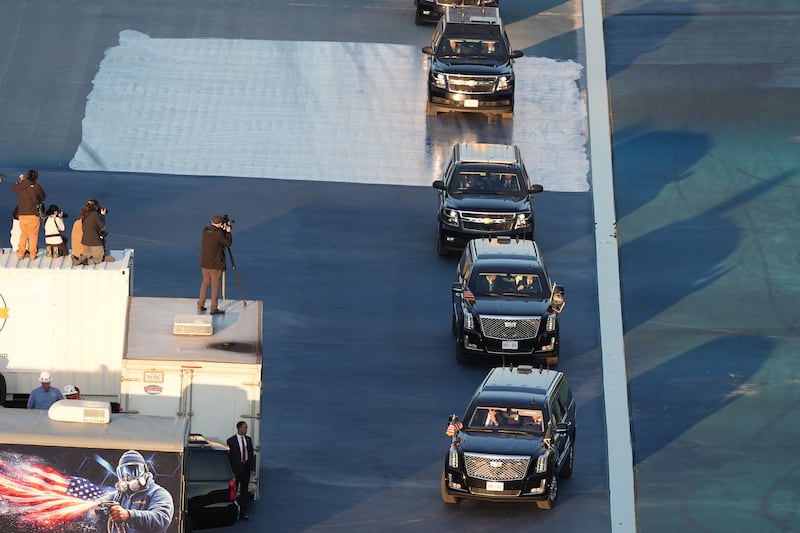 The motorcade with President Donald Trump drives in the Lincoln Memorial Reflecting Pool after a visit to see the new blue protective coating being applied as part of a renovation project on May 7, 2026, in Washington.