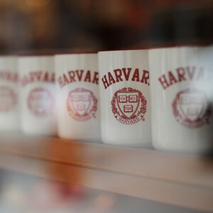 Mugs bearing the school's logo are displayed for sale outside Harvard University in Cambridge, Massachusetts.