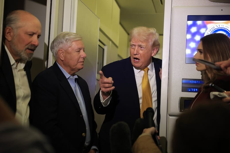 IN FLIGHT - JANUARY 04:  U.S. President Donald Trump, Commerce Secretary Howard Lutnick (L) and U.S. Sen. Lindsey Graham (R-SC) (C) speak to the media aboard Air Force One enroute to Washington, DC on January 04, 2026. Trump is returning to the White House after giving the order for the United States law enforcement to capture Venezuelan President Nicolás Maduro and his wife. (Photo by Joe Raedle/Getty Images)
