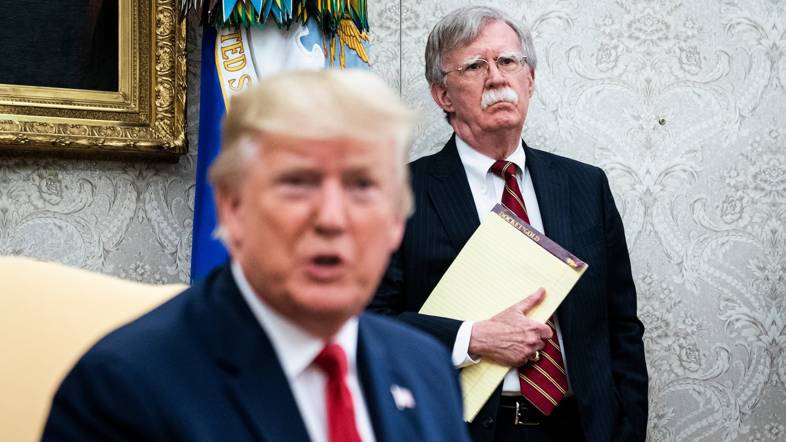 John Bolton listens as President Donald Trump speaks in the Oval Office at the White House on Thursday, July 18th, 2019 in Washington, DC.