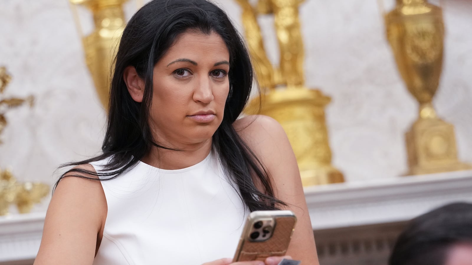 WASHINGTON, DC - MAY 30: White House Deputy Chief of Staff Stephen Miller's wife, Katie Miller, listens as U.S. President Donald Trump and Tesla CEO Elon Musk speak to reporters in the Oval Office of the White House on May 30, 2025 in Washington, DC. Musk, who served as an adviser to Trump and led the Department of Government Efficiency, announced he would leave his role in the Trump administration to refocus on his businesses. (Photo by Kevin Dietsch/Getty Images)