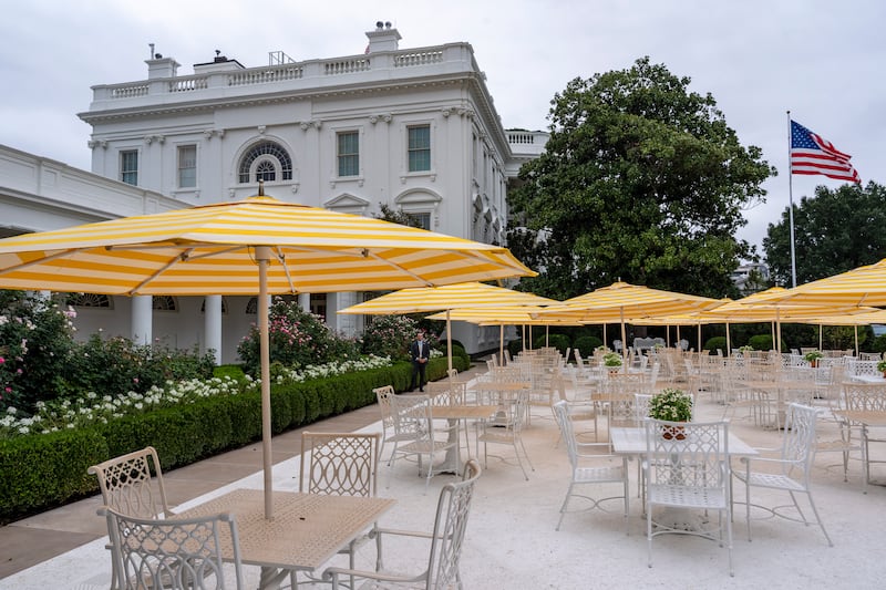 WASHINGTON, DC - AUGUST 19: Yellow and white striped umbrellas are open in the recently renovated Rose Garden on August 19, 2025 in Washington, DC. Reporters were brought out to see the newly renovated Rose Garden and hear the new sound system. (Photo by Alex Brandon-Pool/Getty Images)
