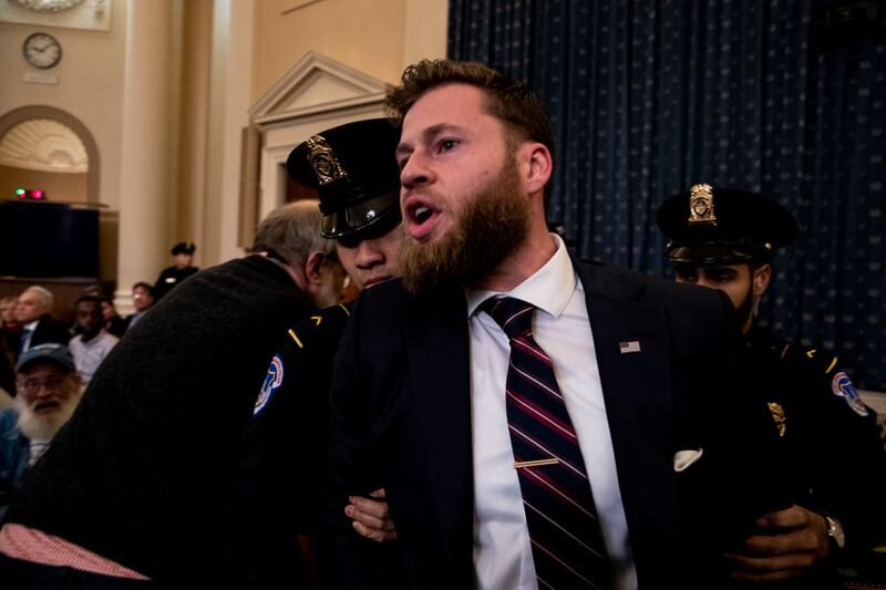 Owen Shroyer from InfoWars is removed from a public impeachment inquiry hearing with the House Judiciary Committee in the Longworth House Office Building on Capitol Hill December 9, 2019 in Washington, DC. The hearing is being held for the Judiciary Committee to formally receive evidence in the impeachment inquiry of President Donald Trump, whom Democrats say held back military aid for Ukraine while demanding they investigate his political rivals. The White House declared it would not participate in the hearing. (Photo by Anna Moneymaker-Pool/Getty Images)