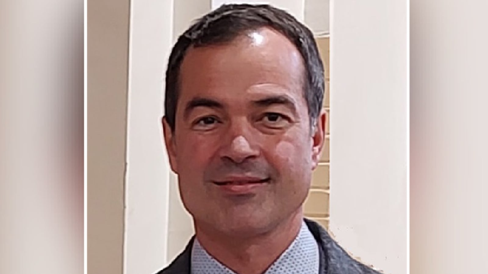 A headshot of Devon Hoover smiling and looking forward.