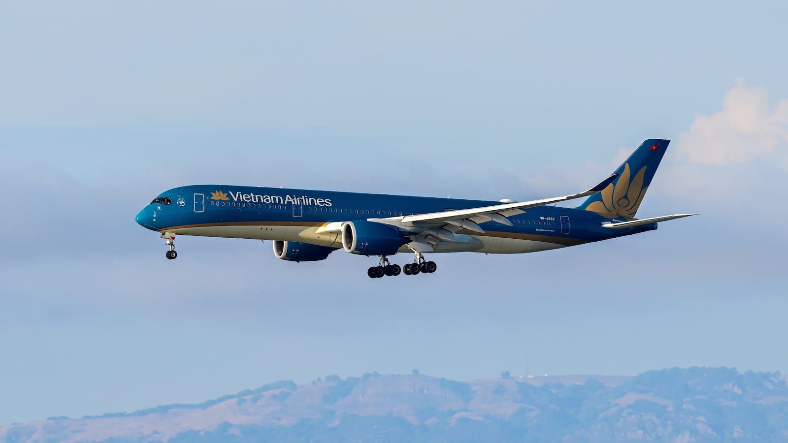 SAN FRANCISCO, CALIFORNIA - JULY 24: A Vietnam Airlines plane lands as a Swiss Air plane is taxiing to takeoff at San Francisco International Airport (SFO) in San Francisco, California, United States on July 24, 2025. (Photo by Tayfun Coskun/Anadolu via Getty Images)