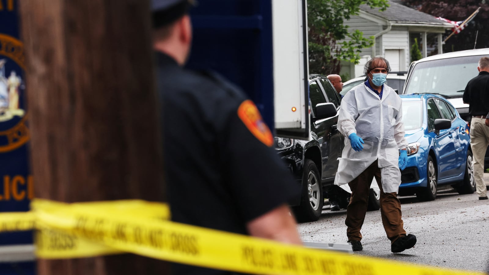 A crime scene investigator walks outside the residence of architect Rex Heuermann, the man arrested in connection with several Gilgo Beach murders, in Massapequa Park, New York, July 21, 2023.