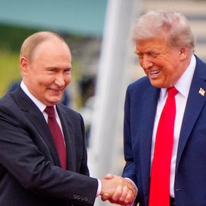 U.S. President Donald Trump (R) greets Russian President Vladimir Putin as he arrives at Joint Base Elmendorf-Richardson on August 15, 2025 in Anchorage, Alaska.