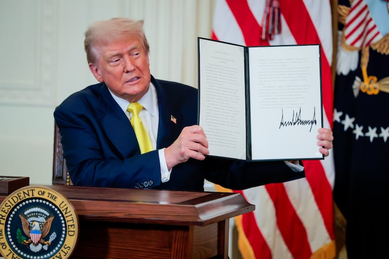 President Donald Trump signs a National Purple Heart Day Proclamation during an event to honor recipients of the Purple Heart in the East Room of the White House on August 07, 2025 in Washington, DC.
