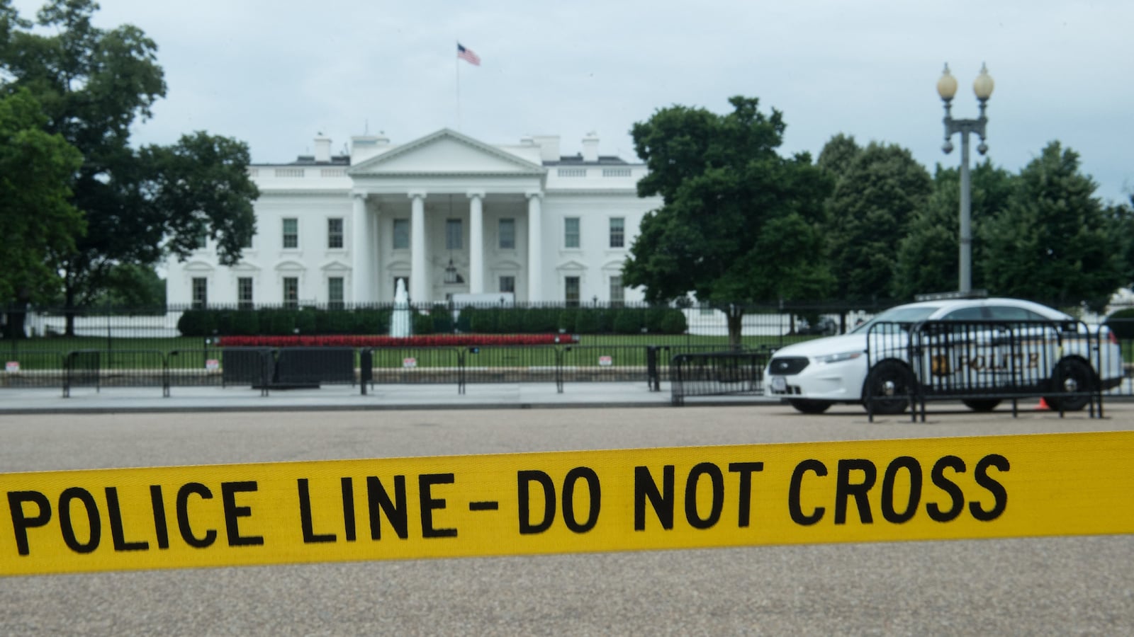Police tape hangs along Pennsylvania Avenue across from the White House in Washington, DC, on June 15, 2017.