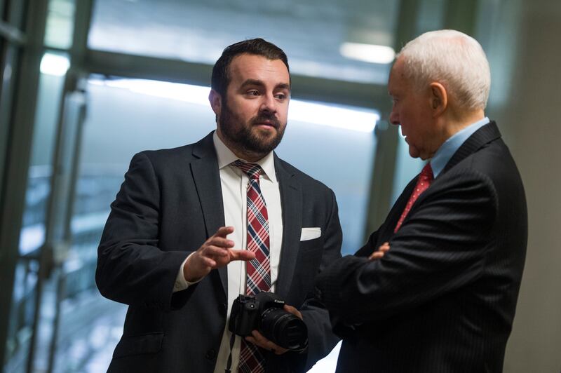 Matt Whitlock, communications director for Sen. Orrin Hatch, R-Utah, right, is seen with his boss in the basement of Hart Building on October 25, 2017.