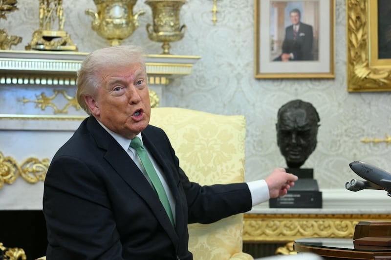 US President Donald Trump points at a bust of Sir Winston Churchill during a bilateral meeting with the Taoiseach of Ireland Micheál Martin in the Oval Office of the White House in Washington, DC on March 17, 2026.