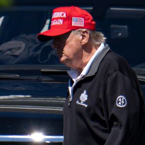 WASHINGTON, DC - AUGUST 30: U.S. President Donald Trump walks with his grandchild Spencer Trump after golfing at Trump National Golf Club on August 30, 2025 in Washington, DC. Trump is spending his Labor Day weekend in Washington, DC after deploying the National Guard to Washington this month. (Photo by Kayla Bartkowski/Getty Images)