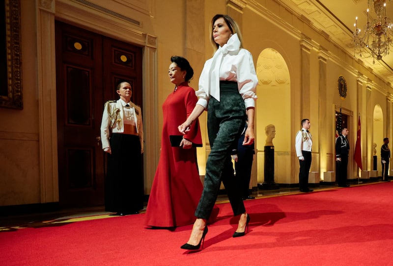 U.S. first lady Melania Trump and Peng Liyuan, the wife of Chinese President Xi, walk at the White House on the day US President Donald Trump hosts a state dinner for China's President Xi Jinping in Washington, D.C., US, September 24, 2026.
