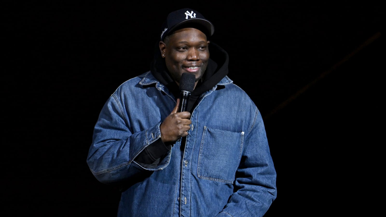 NEW YORK, NEW YORK - DECEMBER 10: Michael Che performs onstage during the Comic Relief Live 2025: A Benefit to Build Brighter Futures for Kids at Carnegie Hall on December 10, 2025 in New York City. (Photo by Roy Rochlin/Getty Images for Comic Relief)