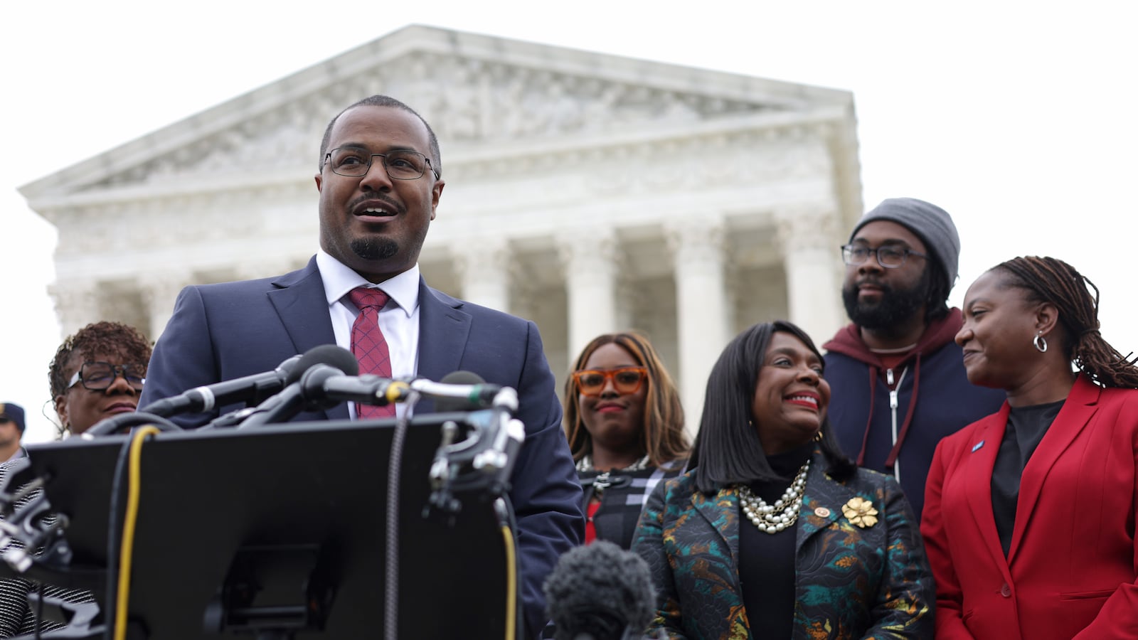 Lead counsel for the plaintiffs Deuel Ross (2nd L) speaks to members of the press as President and Director-Counsel of the NAACP Legal Defense Fund