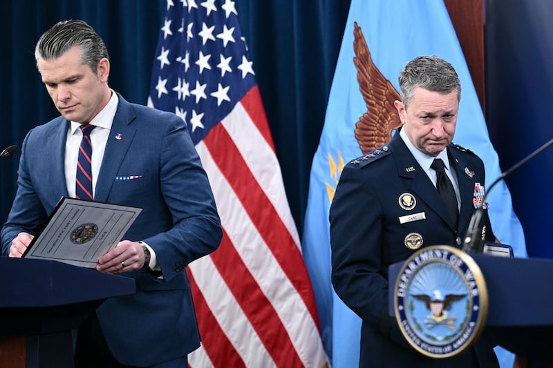 (L/R) US Defense Secretary Pete Hegseth and the Chairman of the Joint Chiefs of Staff General Dan Caine arrive for a press conference on US military action in Iran, at the Pentagon in Washington, DC, on March 2, 2026. The United States hit hundreds of targets across Iran, and Israel expanded its bombing to Lebanon on Monday as President Donald Trump vowed to avenge the first US deaths in the war he launched to topple Tehran's ruling clerics. Iranian forces fired missiles and drones across the Middle East, killing people in Israel and the United Arab Emirates, in retaliation for the conflict that began February 28 with the death of Iran's supreme leader, Ayatollah Ali Khamenei. (Photo by Brendan SMIALOWSKI / AFP via Getty Images) / ALTERNATE CROP