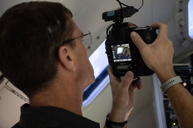 A man holds a camera.