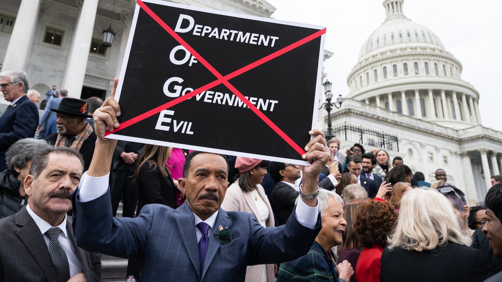 US Representative Kweisi Mfume, Democrat of Maryland, holds a sign against DOGE
