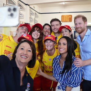 Meghan, Duchess of Sussex and Prince Harry, Duke of Sussex pose for a selfie photo as they meet volunteer first responders from Bondi Surf Bathers' Life Saving Club, during a visit to Bondi Beach, on day four of the royal trip to Australia on April 17, 2026 in Sydney, Australia. Volunteers from the organization, founded in 1907, played an integral role in protecting beachgoers and saving lives during the terrorist attack at Bondi Beach on December 14.