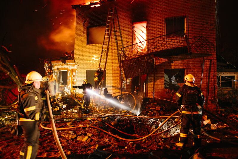 Firefighters extinguish a fire in a private residential building that is damaged by Russian shelling, in Kharkiv, Ukraine, on April 29, 2025
