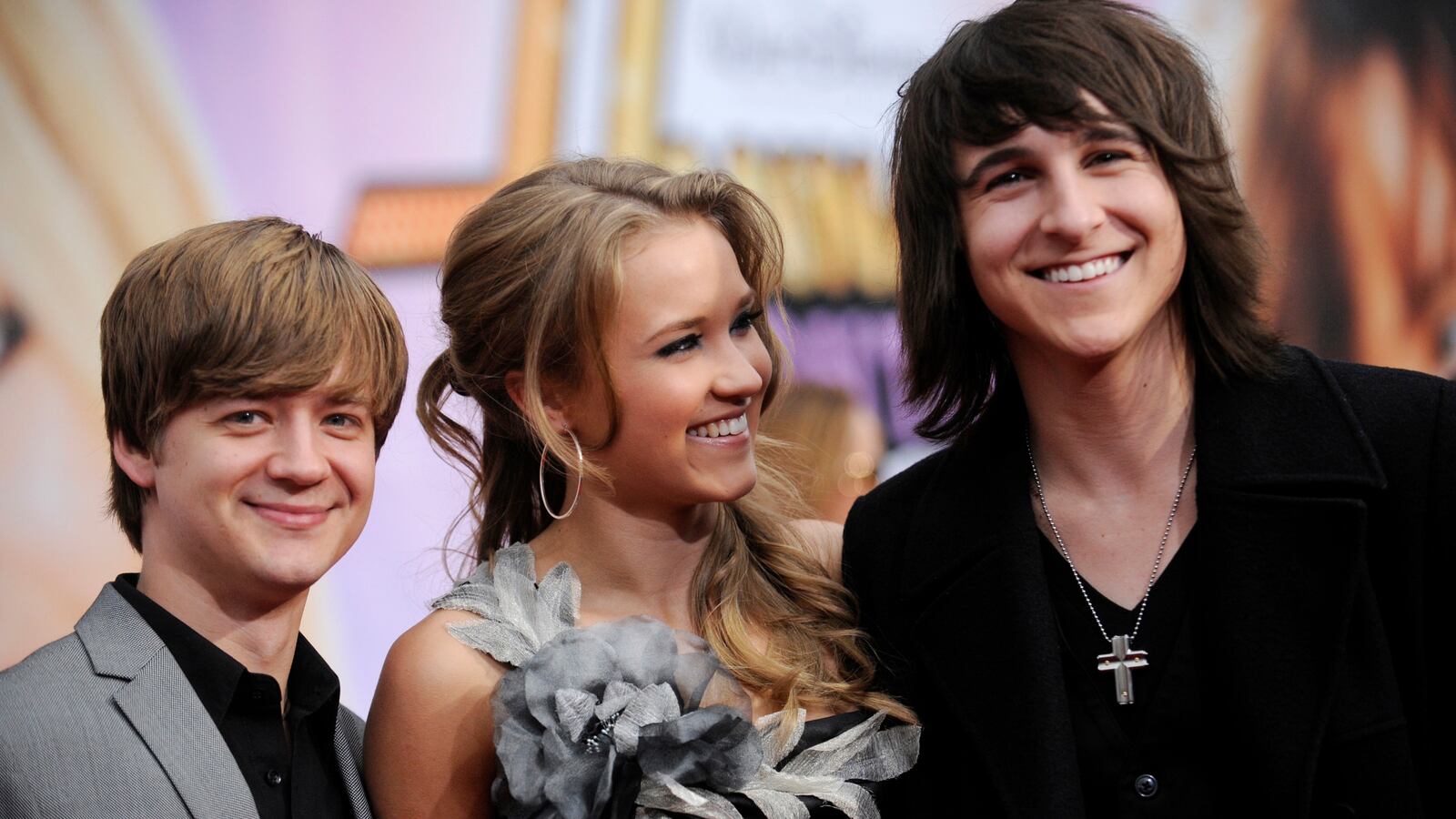 Cast members Jason Earles (L), Emily Osment (C) and Mitchell Musso (R) attend the premiere of "Hannah Montana the Movie" in Los Angeles April 2, 2009.