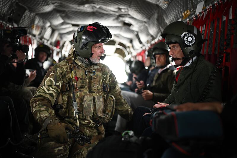WARMINSTER, ENGLAND - JUNE 3: Defence Secretary John Healey speaks with flight crew as he visits Warminster Garrison on June 3, 2025 in Warminster, United Kingdom. As part of the Strategic Defence Review, John Healy announces that drone manufacturing in the UK will be enhanced by a £2 billion investment in autonomous and uncrewed drones, which will strengthen the Armed Forces' lethal battlefield capabilities. A further £1 billion is to be dedicated to the British laser-directed energy weapon DragonFire and the development of a new Drone Centre.  (Photo by Leon Neal/Getty Images)