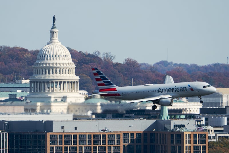 UNITED STATES - NOVEMBER 7: An American Airlines Airbus A320 plane passes by the U.S. Capitol dome in Washington as it comes in for a landing at Ronald Reagan Washington National Airport on Friday, November 7, 2025. Starting today the Federal Aviation Administration forced airlines to cut 10% of flights at 40 busy airports, including Washington National, to reduce the load on air traffic controllers during the government shutdown. (Bill Clark/CQ-Roll Call, Inc via Getty Images)