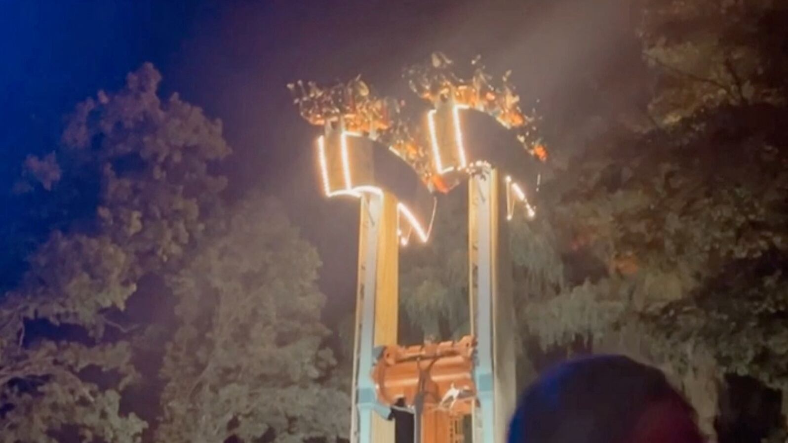 A person reacts as people get stuck upside down on a malfunctioned amusement park ride in Vaughan, Ontario, Canada, Sept. 23, 2023